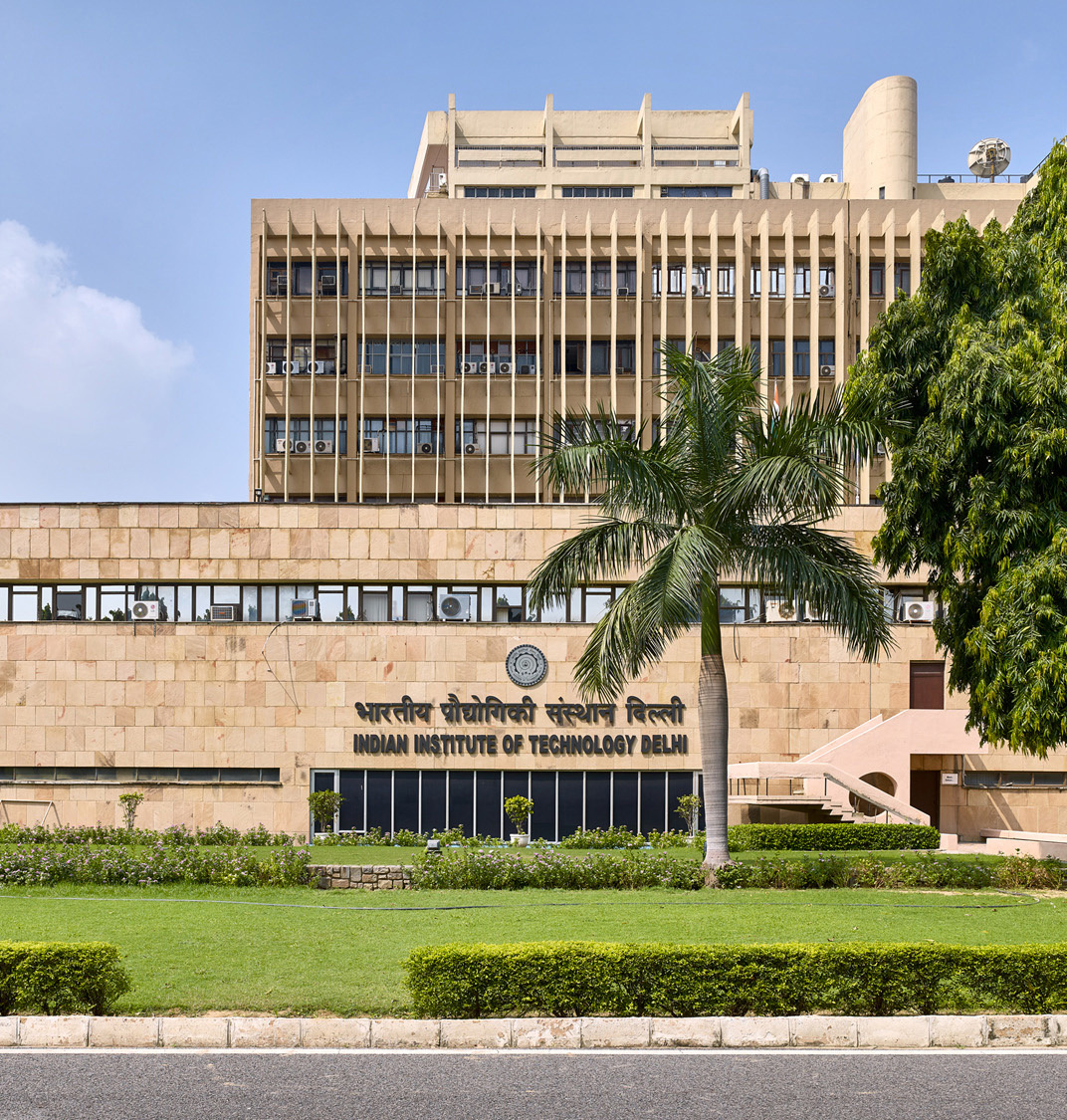 Aerial view of the majestic IIT Delhi building surrounded by a lush green campus.